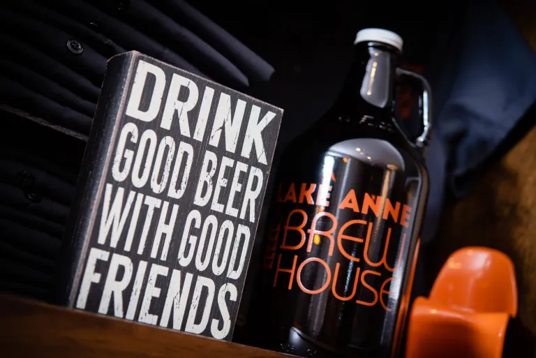 Events and Calendars page image is a photograph. It has a black backgournd with a brown growler with text in orange that reads "Lake Anne Brew House." There is a sign to the left of the growler that reads "Drink good beer with good friends."