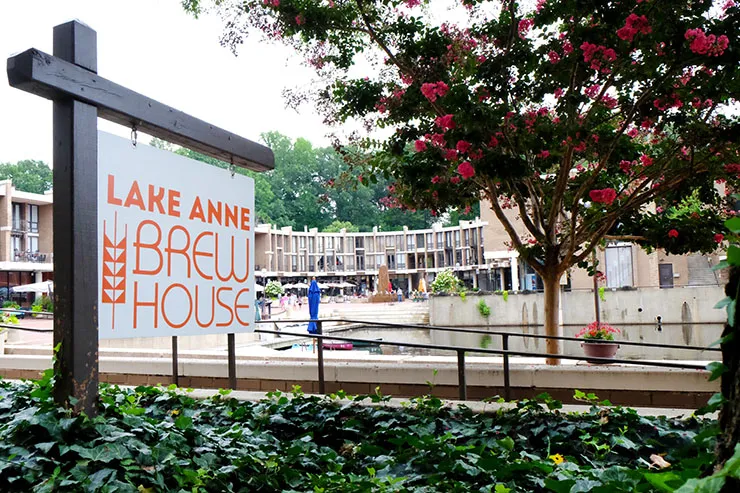 Image of outside the Lake Anne Brew House with the sign in the foreground.
